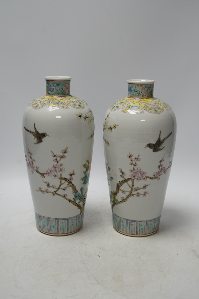 A pair of Chinese famille rose tapering vases, Qianlong mark but later, 23cm. Condition - good